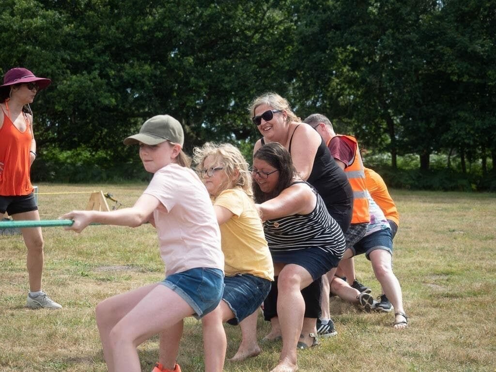 people doing tug of war at shine camp