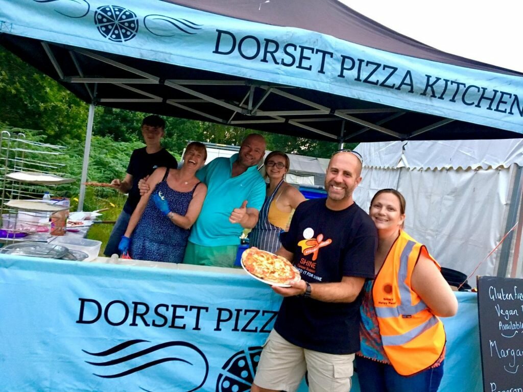 pizza being served at shie camp